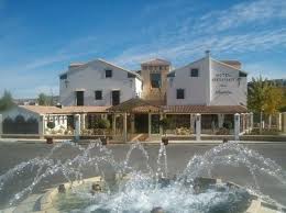 A puréed and simmering carrot soup in a pot with a spoon